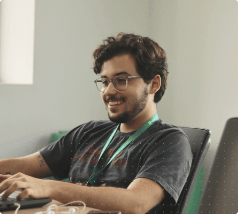A man smiling with a laptop